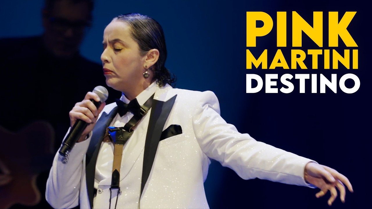 Check out everything Pink Martini here: 
https://linktr.ee/pinkmartiniofficial
---
Enjoy this incredible performance of Destino, one of the fantastic songs from Pink Martini's recently released EP, Bella ciao.  Sung by our regular and show-stopping guest singer, Edna Vazquez, this song is becoming a fresh and new fan favorite at our live shows.  This performance was filmed on May 14, 2025, the song and EP's release day, in Paris, France at the incredible Accor Arena.  
---
LYRICS
Now I can smile and say  

Destino  
My heart was sad and lonely  
In knowing that you only  
Could bring my love to me  

Destino  
This heart of mine is thrilled now  
My empty arms are filled now  
As they were meant to be  

For you came along  
Out of a dream I recall  
Yes you came along  
To answer my call  

I know now  
That you are my destino  
We'll be as one for we know  
Our destiny of love 
---
LINEUP: 
Thomas M. Lauderdale, piano and bandleader
Edna Vazquez, lead vocals
Phil Baker, upright bass
Dan Faehnle, guitar
Nicholas Crosa, violin
Mihail Iossifov, trumpet
Antonis Andreou, trombone
Reinhardt Melz, drums
Brian Davis, percussion
Miguel Bernal, percussion
Timothy Nishimoto, percussion and backup vocals
Storm Large, backup vocals
Sofia von Trapp, backup vocals
China Forbes, backup vocals
---
CREW:
Greg Tamblyn, tour manager
Will Reischman, stage manager
Pete Plympton, sound engineer
---
FILMING AND EDITING:
Filmed by and courtesy of Accor Arena
Edited by Rick Ring Photography
-----------------------------------------------

FIND PINK MARTINI ONLINE: 
Official Website: http://pinkmartini.com/
Instagram: https://www.instagram.com/pinkmartini/ 
Facebook: https://www.facebook.com/pinkmartini
TikTok: https://www.tiktok.com/@pinkmartiniofficial
Spotify: https://bit.ly/spotifyPM  
Apple Music: https://bit.ly/pinkMartini
SoundCloud: https://soundcloud.com/heinzrecords
bandcamp: https://pinkmartini.bandcamp.com/ 
Pink Martini Fan Club: https://www.patreon.com/pinkmartini
The Official Pink Martini Store: http://store.pinkmartini.com/

#pinkmartini #destino #ednavazquez