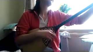 Takes Daughter Playing The Dombra - Kazakh National Instrument