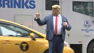 Man in Trump mask 'directs' New York traffic outside Trump Tower | AFP