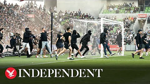 Moment fans storm pitch during Melbourne derby and...