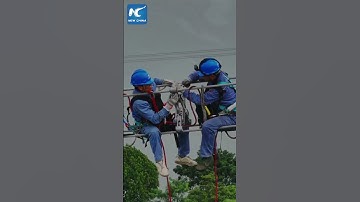 Drones assist electricians in maintaining power lines in China