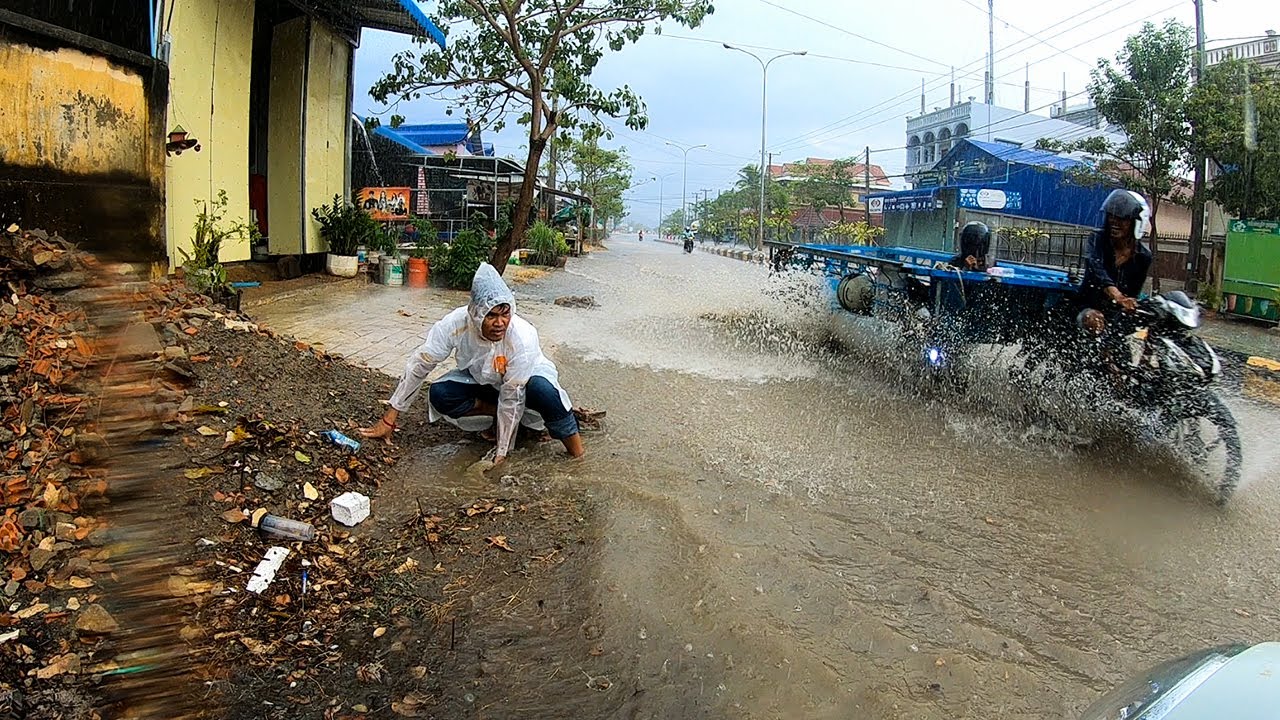 Remove Trash And Plastic Clogged Culvert Drain Flood Rain On Street ...