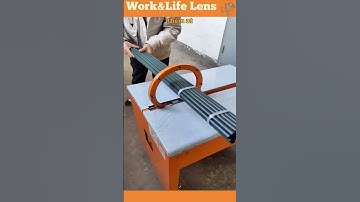 Operator feeds pipes into rotary wrapping machine for automated, consistent packaging.