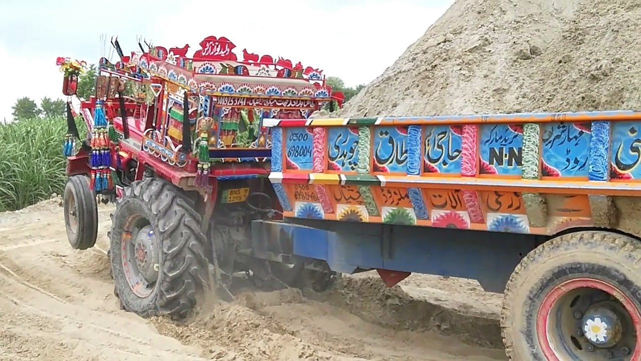 Mf 260 turbo Tractor pulling a very heavy loaded Trolley with stunts