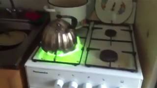 Gas stove burning with green flame