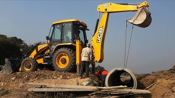 JCB Backhoe 3DX Lifting Heavy Culvert Pipe and Installing in Drain