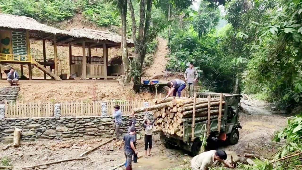 The girl and her neighbors are cutting down trees to load onto a truck