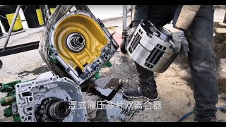 A Chinese man repairs the  power shift transmission of a John Deere tractor