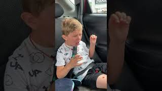 Little boy eats sushi in the back of car for the first time and doesn't like it so he spits it up