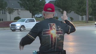 Urbandale man waves at morning commuters at busy intersection to brighten their day