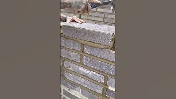 the process of installing bricks in building a house fence