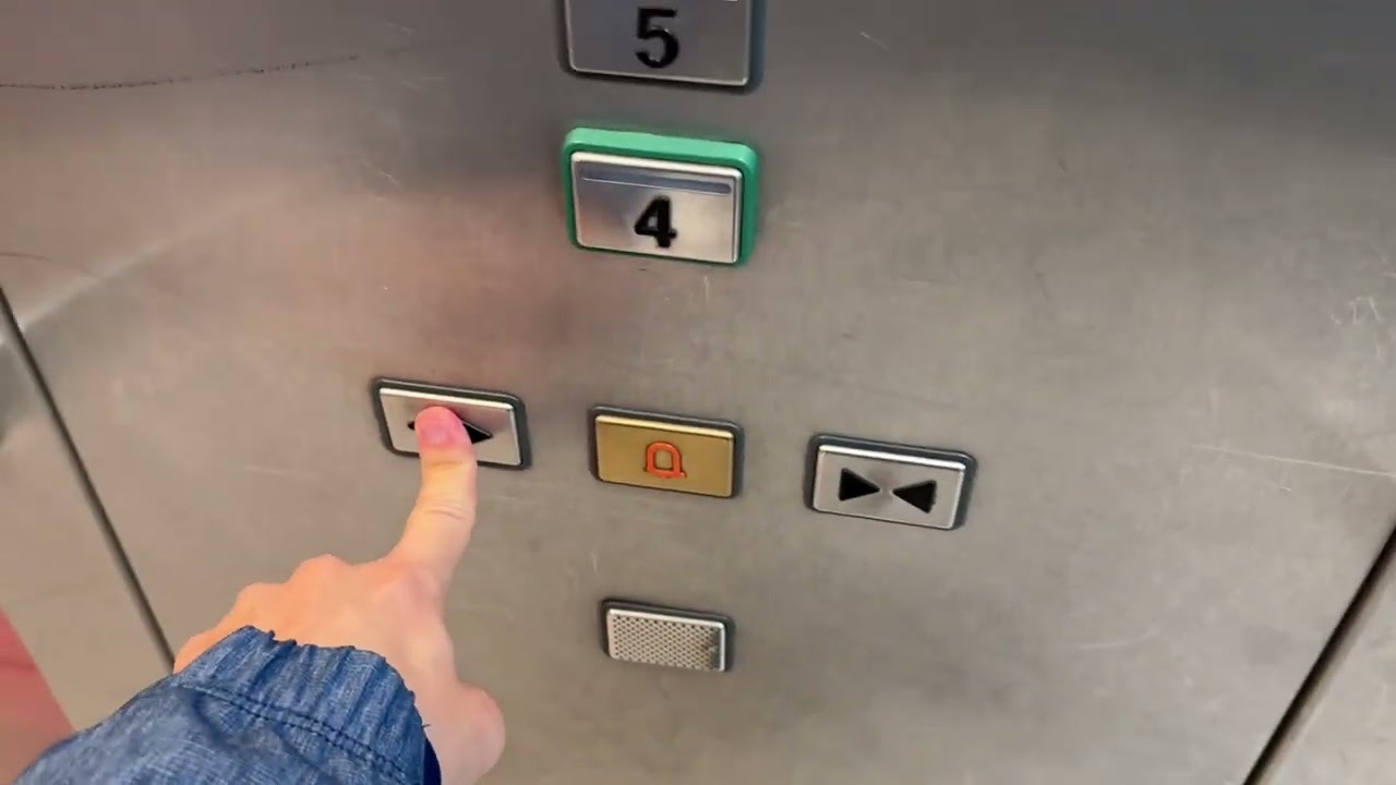 Busy Schindler 2600 MRL Traction Glass Elevator at LHR Heathrow Airport in London, England