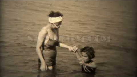 1938: Women in white round sunglasses and old timey bathing suit. TRYON, NC
