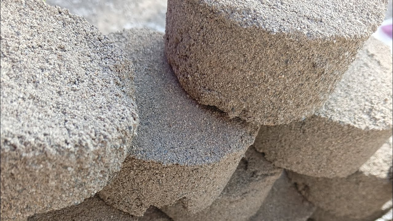 Dry sand crumbling in bucket 