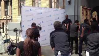 Celebrity pops out of step and repeat banner!