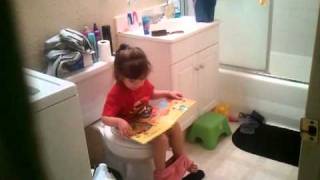 Irelyn Luna going potty reading her Monkey book