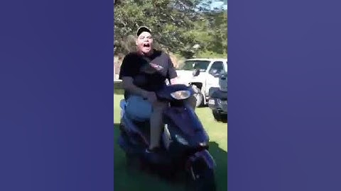 Fat guy falls off of moped