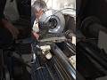 VETERAN SHOWING OFF HIS MACHINING SKILLS ON PARALLEL MANUAL LATH IN MECHANICAL WORKSHOP