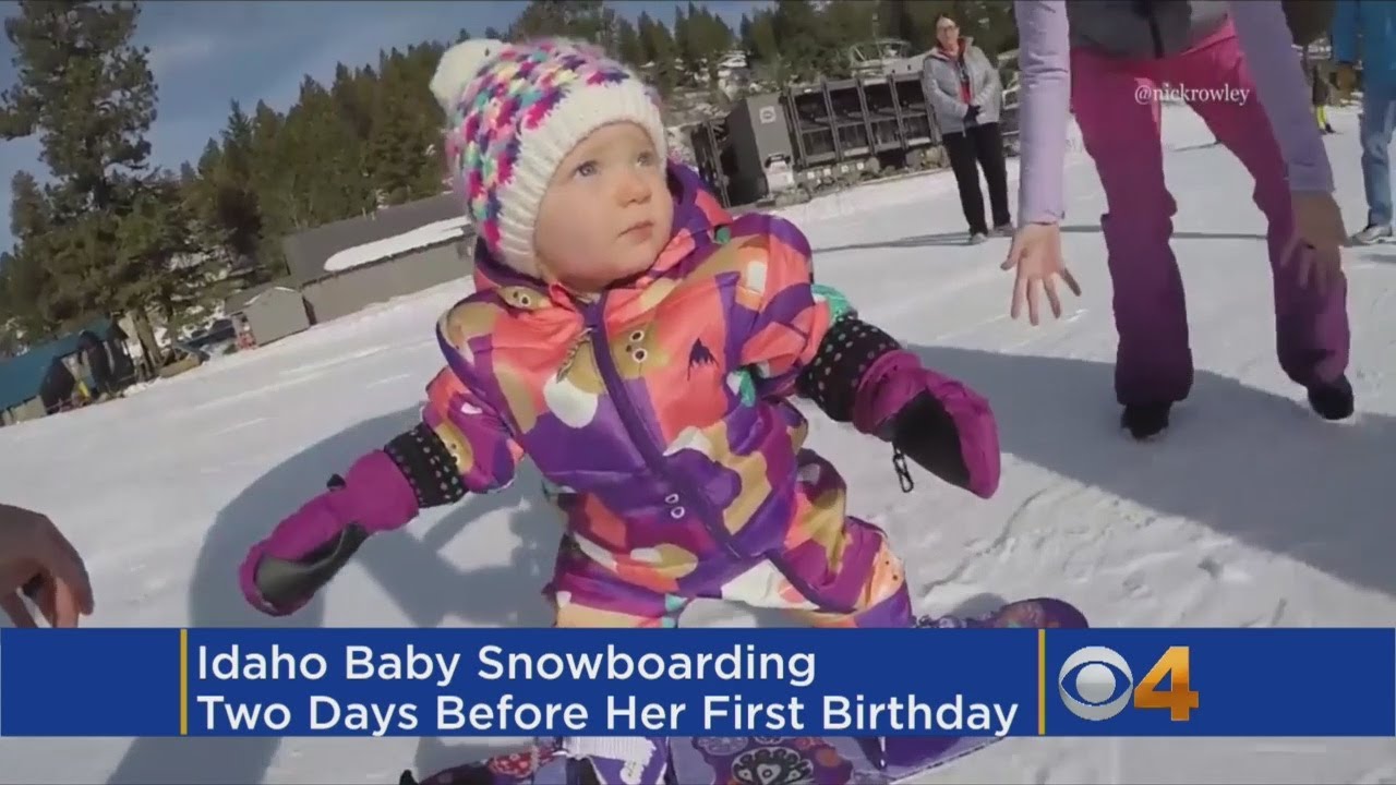 baby snowboarder hitting the