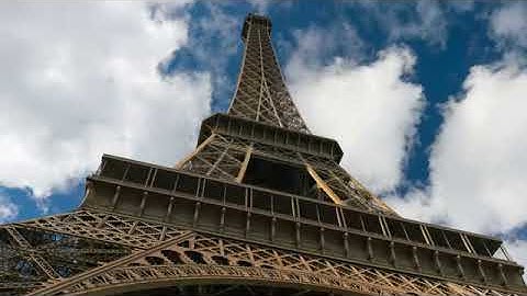 Eiffel tower blue sky with clouds down to top view hyperlapse