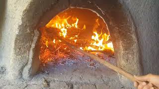 Village Bread - She is baking  Breads in a Traditional Wood Fired Oven