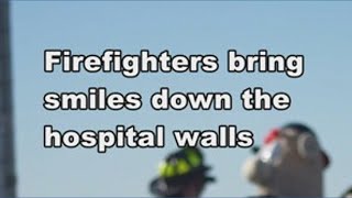 Firefighters rappel down hospital to spread holiday cheer