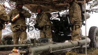 Royal Artillery gunners fire their 105mm light guns durin...