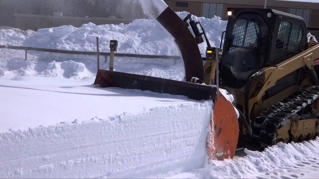 Rick operating homemade 7' wide hydraulic snowblower at Dover NH High