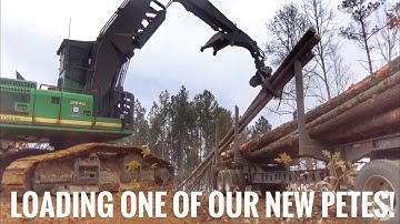 Loading logs with a John Deere log loader