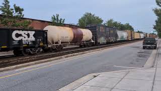 CSX 148 and CSX 4547 lead a BIG nb mixed freight down Winslow Street in Fayetteville 5/29/2026