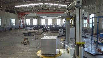 Automatic stretch wrapper with top sheet dispenser