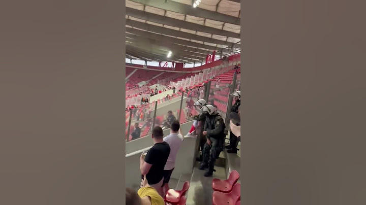 Aston Villa fan with a Panathinaikos scarf whilst this Olympiacos fan  holds Birmingham badge