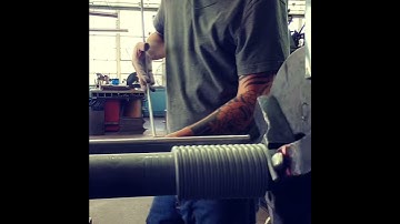 Coiling an extension spring on a lathe.
