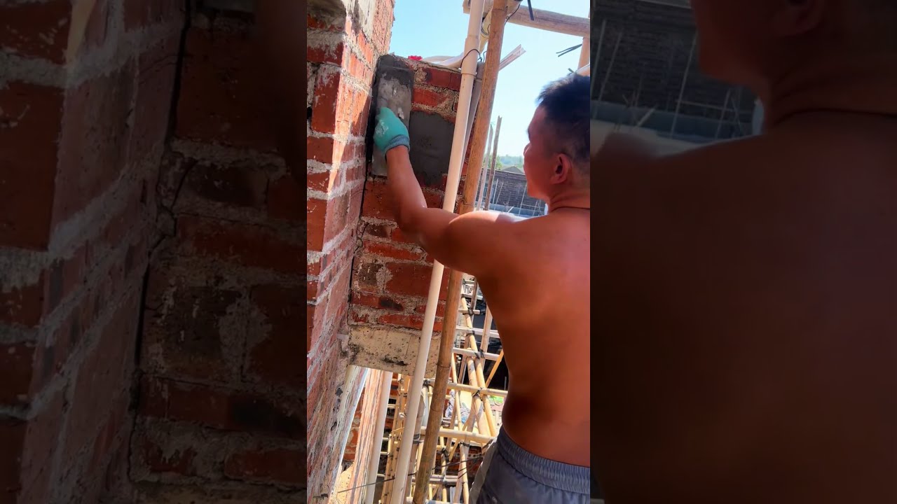 The process of laying a steel rod and plastering a brick wall