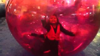 Two girls in an inflatable giant ball