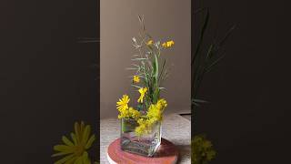 Arrangement of Yellow Wildflowers and Succulents in a Clear Glass Vase