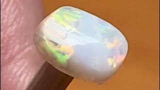 Cut Opal Gems From Australia Displayed Under Cloudy Weak Sun Light And Torch Light For Comparison.