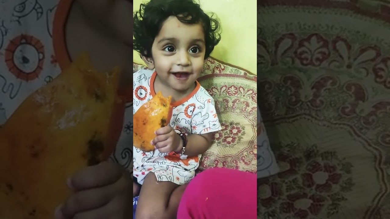 baby eating papaya