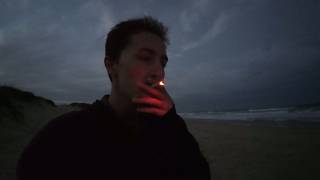 Smoking a Cigarette on the Beach in Brazil Right After Sunset