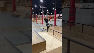 Boy on skateboard grinds rail at skatepark then falls forward and lands in scorpion position