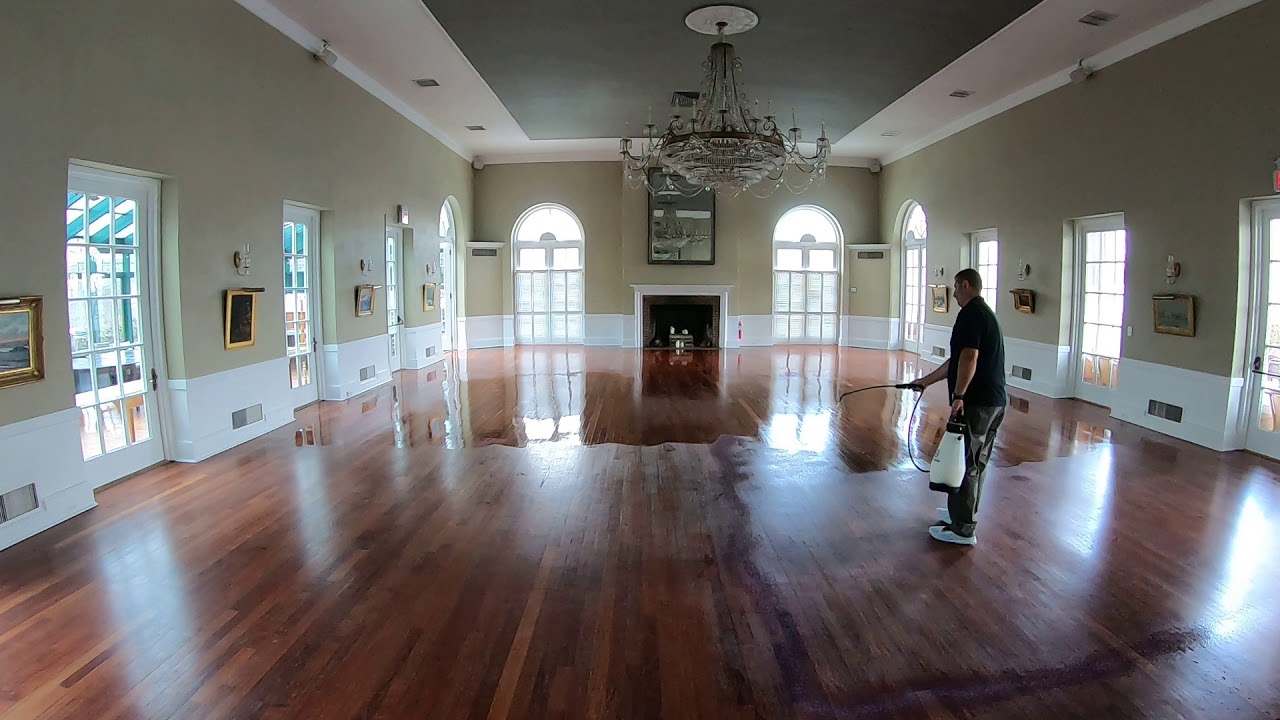 Hardwood floor revitalization - first coat of three costs of finish being applied