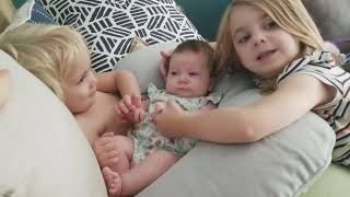 zaylia 2 months old being cuddled and loved by her big sisters who are 2yrs and 5yrs old