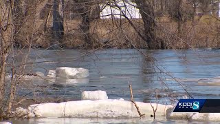 Raccoon River swollen over Highway 169 in Adel