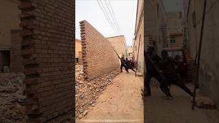 Small Force, Big Impact: The Physics of Using Leverage to Topple High Walls