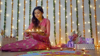 Download Lagu A young woman in traditional wear putting oil lamps on a color... | Indian Stock Footage | Knot9 MP3
