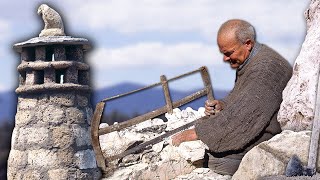 Fireplace with rough stone. Manual extraction and cutting with axes and saws for construction