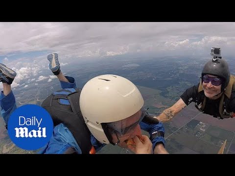 Incredible moment team of skydivers eat pizza mid-air