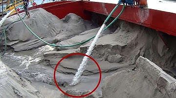 Hydraulic Sand Unloading: High-Pressure Water Pump in Action on a River Barge