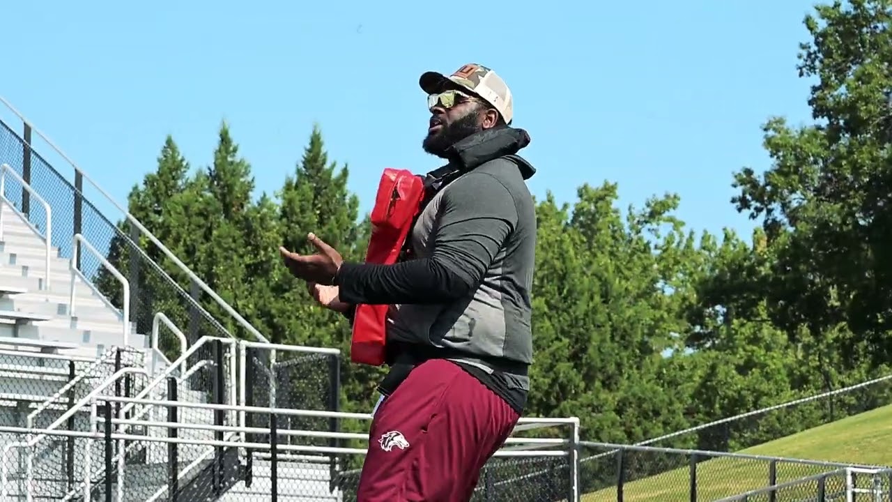 Coach Darius Davis teaches technique in D-Line drill