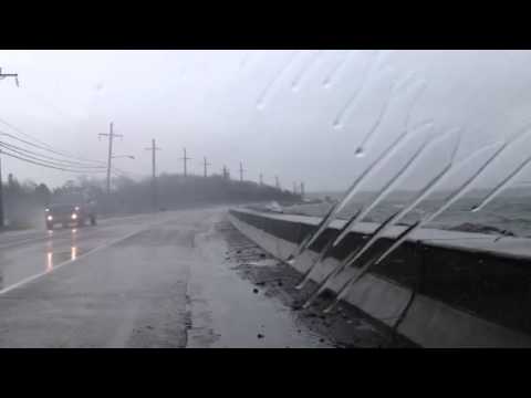 Water blows over Orient Causeway in East Marion